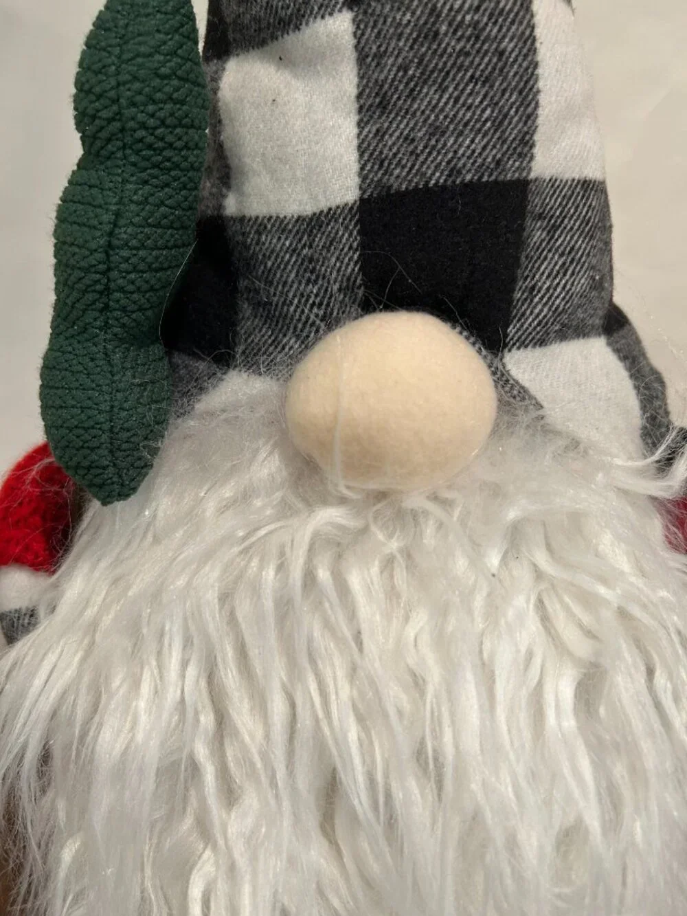 Christmas Holiday Gnome with bean bag base and bell on cap holding a tree